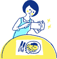 スマホで料理の写真を撮る主婦