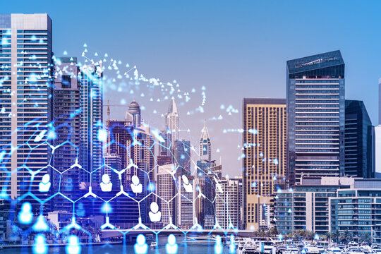 Skyscrapers of Dubai business downtown. International hub of trading and financial services. Social network icons hologram, concept of human resources. Double exposure. Dubai Canal waterfront.
