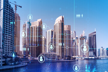Skyscrapers of Dubai business downtown. International hub of trading and financial services. Social network icons hologram, concept of human resources. Double exposure. Dubai Canal waterfront.