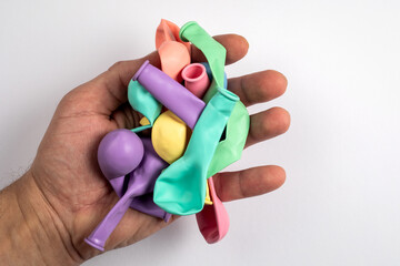 Colored balloons in a man's hand on a white background