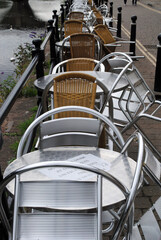 Fototapeta na wymiar Empty Shiny Steel Tables and Chairs on Riverside Cafe 