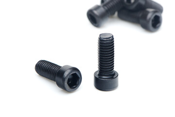 Two black hex screws with hex cap head close up isolated on white background