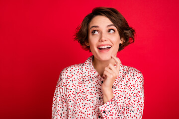 Portrait of charming amazed cheerful brown-haired girl creating new solution isolated over bright...