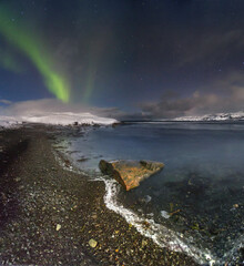 Northern Lights over the bay of the Barents Sea. Kola Peninsula. Murmansk region. russia