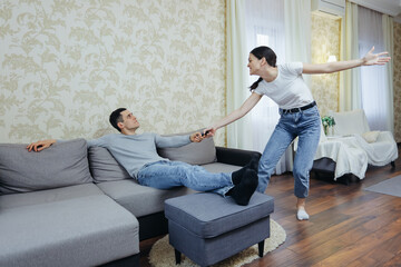 The husband is watching TV. Wife screams and interferes with watching a football match