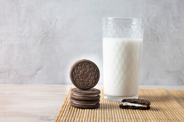 Chocolate cookies with a glass of milk on a wooden table