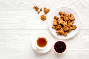 Breakfast with cookies berry jam and tea