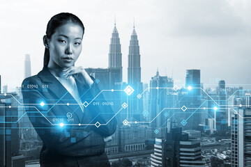 Attractive young Asian businesswoman pondering on technology at business process to achieve...