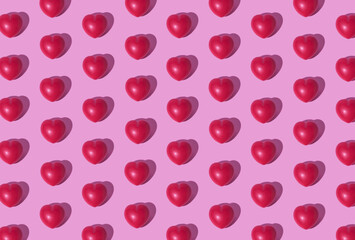 Heart pattern on pink background. Straight. Valentine's card. Full, bulging hearts, aligned on a pink background. Flat lay, perfect for a Valentine's card.