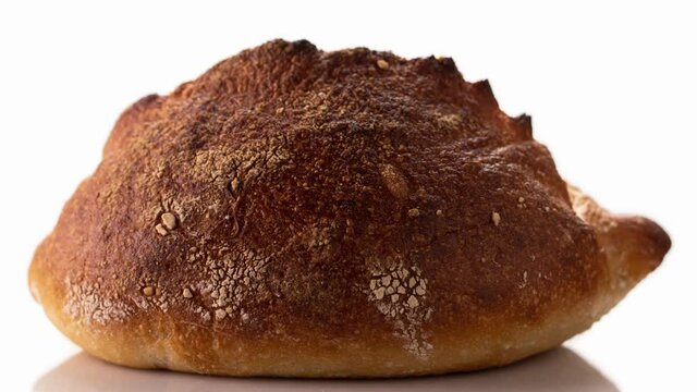 Freshly baked bread rotates on a white background, front view, stop motion, 3D.
