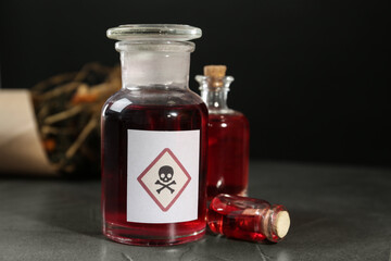 Bottles with poison on grey stone table