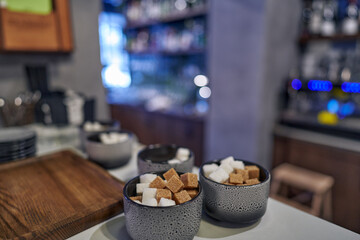 Lump soluble white and brown sugar in bowls. Restaurant cuisine.