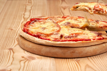 Bright juicy tasty pizza. two floors. Lots of cheese and tomato. Side view.