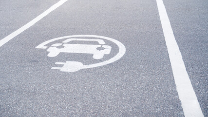 sign on the pavement charging for electric vehicles