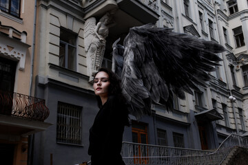 Female angel with dark wings walking