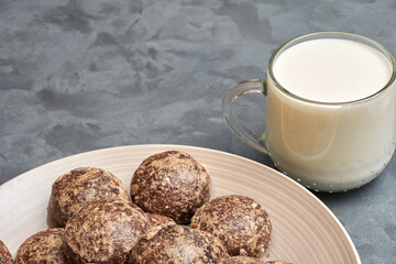 Close-up of a plate with chocolate gingerbread and a mug of milk. Copy space.
