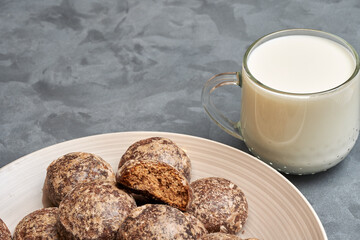 Close-up of a plate with chocolate gingerbread and a mug of milk. Copy space.