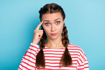 Photo of young serious girl finger touch head think thoughtful ponder isolated over blue color...