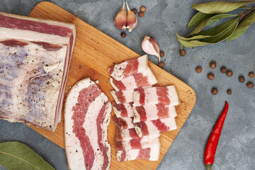 Close-up of homemade lard cut into pieces on a wooden board. A natural product from an organic...