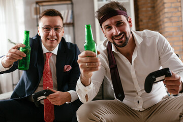 Businessmen playing video games in the office. Colleagues relaxing after meeting