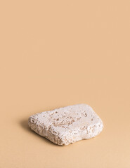 Rock podium for products mock up against beige background.	