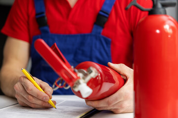 fire safety equipment control - maintenance service engineer checking extinguisher condition and...