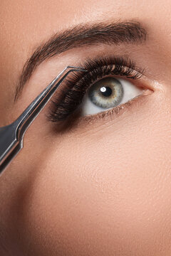 Closeup of female eye during eyelash extension