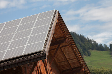 Fototapeta na wymiar Rural scene of an alpine barn with photovoltaic panels