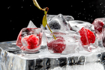 Fresh cherry berries on big ice cube on black background