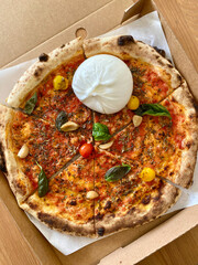 Neapolitian Pizza Marinara with Burrata Cheese, Tomatoes, Oregano and Extra Virgin Olive Oil.