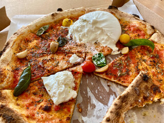 Neapolitian Pizza Marinara with Burrata Cheese, Tomatoes, Oregano and Extra Virgin Olive Oil.