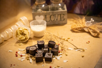 Handmade candies with fresh and dried fruits on light paper background in rustic style