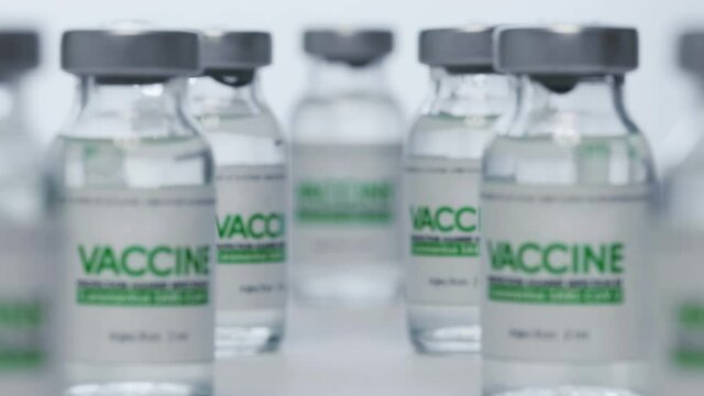 Bottles of vaccine for coronavirus COVID-19 cure are in research lab before injection. Vaccination, clinical trial during pandemic. Flacons, vials. Wide macro slider dolly out shot. SARS-Cov-2. No one