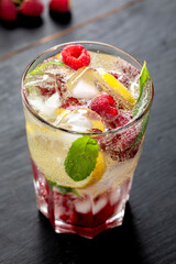 Summer cocktail with raspberry, lemon and mint leaves