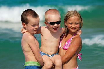 Girl and two boys on the beach