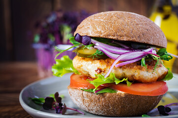 Hamburger. Sandwich with chicken burger, tomatoes,  pickled cucumber and red onion. Fresh tasty...