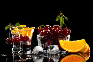 Fresh cocktail with syrup, cherry and orange