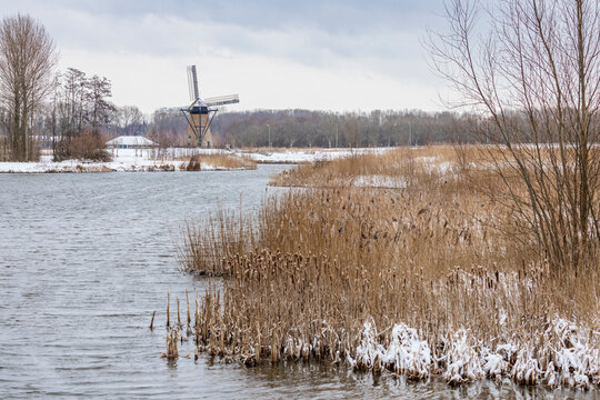 Typical dutch scene with the windmill of Pendrecht in a snowy landscape