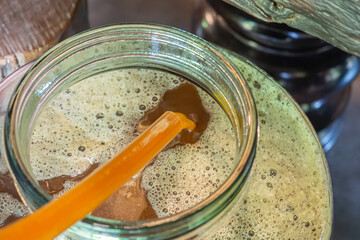 Close-up of craft beer and foam in a fermentation container. Process of making home beer from malt. Craft beer from barley and dark malt