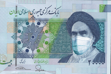 Iran's 20,000 reais banknote with a medical mask. coronavirus epidemics in Iran . the impact of the coronavirus epidemic on Iran's economy and currency