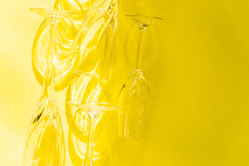 Empty glasses stand on a yellow background, top view.