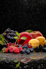 Summer fresh berries and fruits on black background