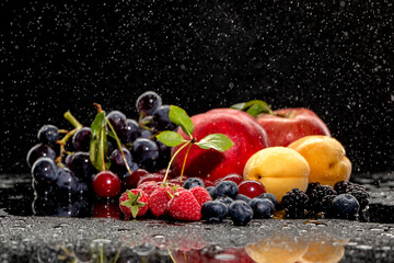 Fototapeta na wymiar Summer fresh berries and fruits on black background