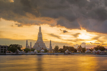 Fototapeta na wymiar Wat Arun Ratchawararam or Temple of Dawn and five pagodas during sunset, famous tourist destination in Bangkok, Thailand