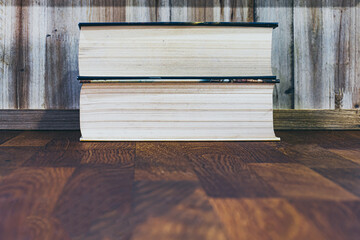 books stacked on wooden table