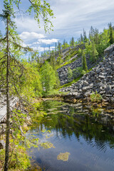 View of The Pyha-Luosto National Park in summer, rocks, stones, trees and natural pond, Lapland, Finland