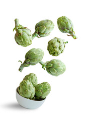 Flying artichokes in a bowl isolated from the white background