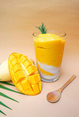 Detox Mango  Smoothie from Ripe mango for healthy on color paper background with empty space for your text or message.