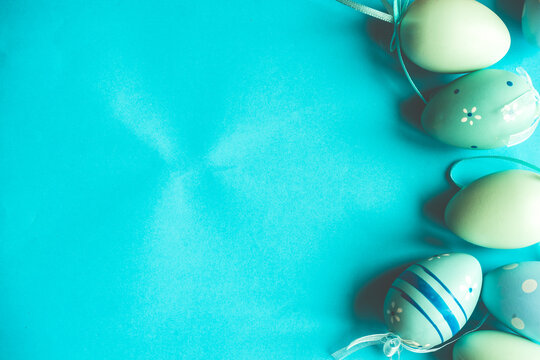 Painted Easter eggs and bird's nests decorations on a blue background