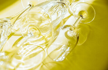 Empty glasses stand on a yellow background, top view.